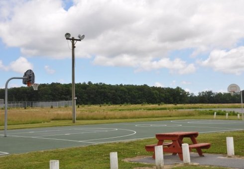 outside basketball court with one net