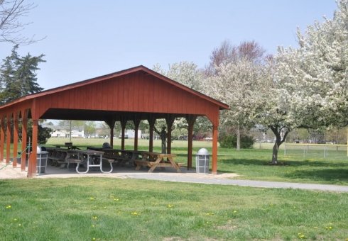 picnic tables under a red pavilion