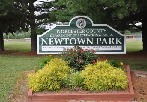 newtown park sign with shrubs