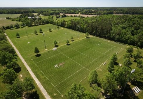 aerial view of three green sports fields