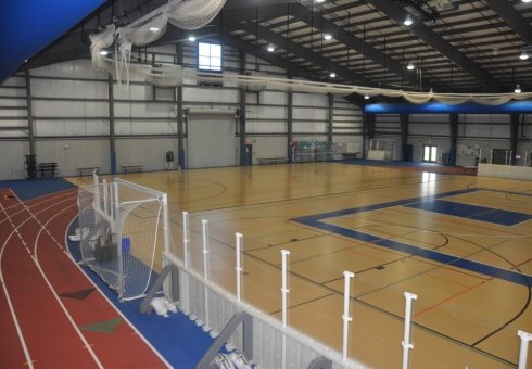 shiny court inside with white fence
