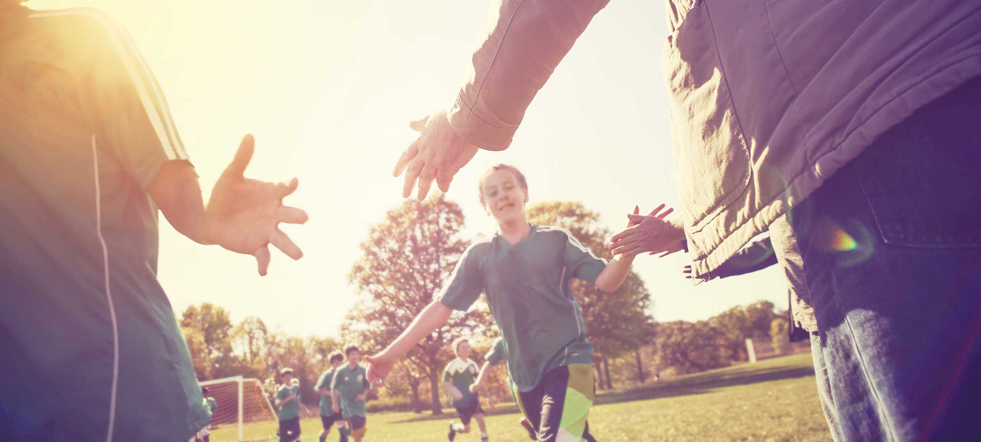 Kids playing soccer at a park